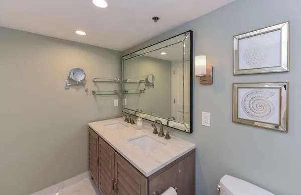 a bathroom with a sink a toilet and a mirror