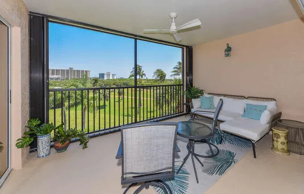 a view of a chairs and table in a balcony