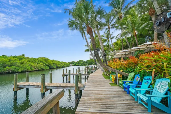 a balcony with wooden floor and lake view