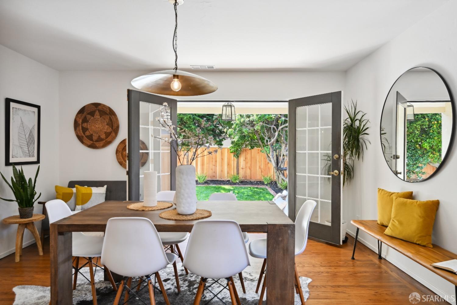 a view of a dining room with furniture a chandelier and wooden floor