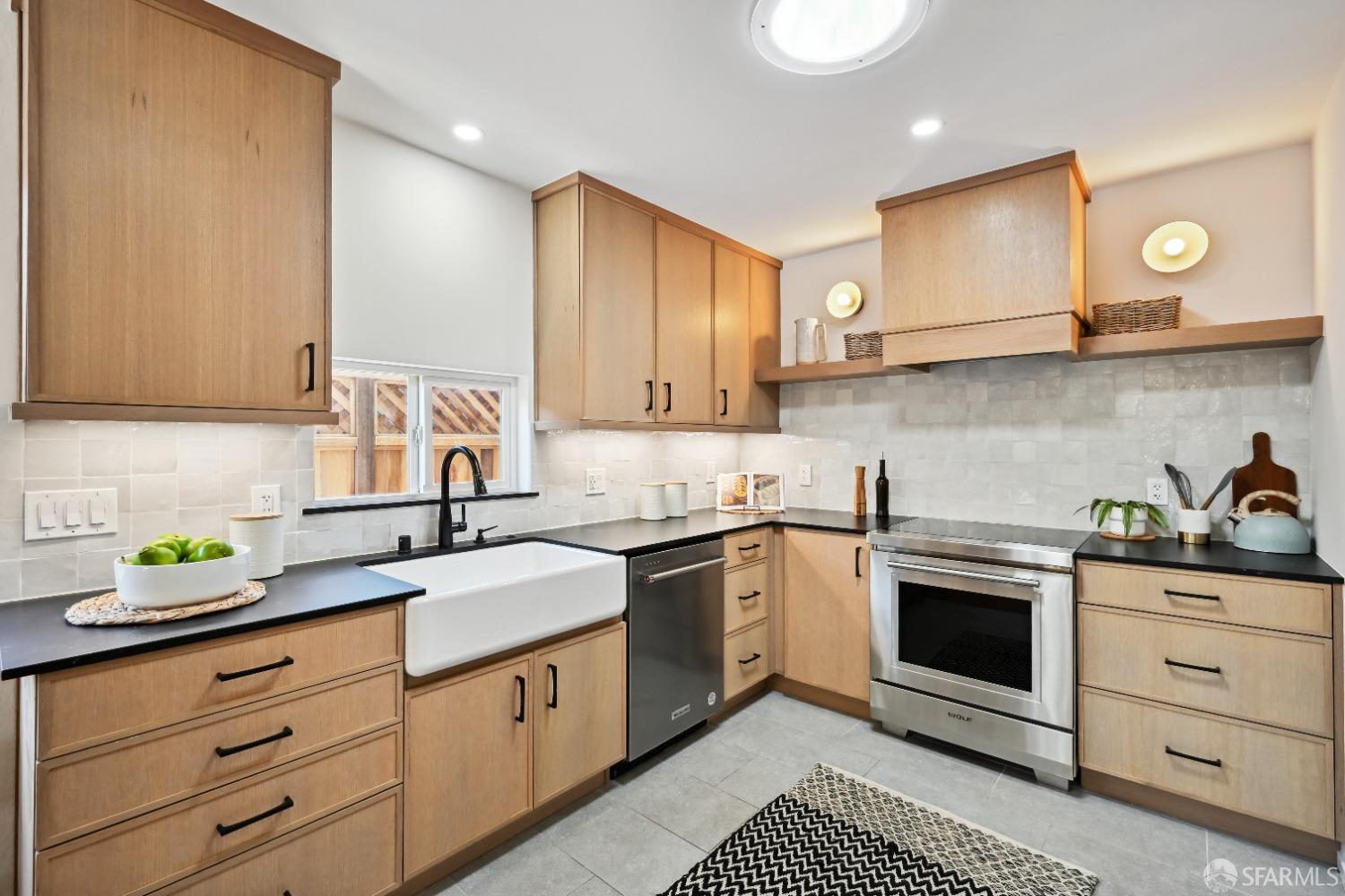 1208 Peach Street Alameda, CA 94501 - Photo 10 of 31 a kitchen with granite countertop stainless steel appliances a stove a sink and a microwave