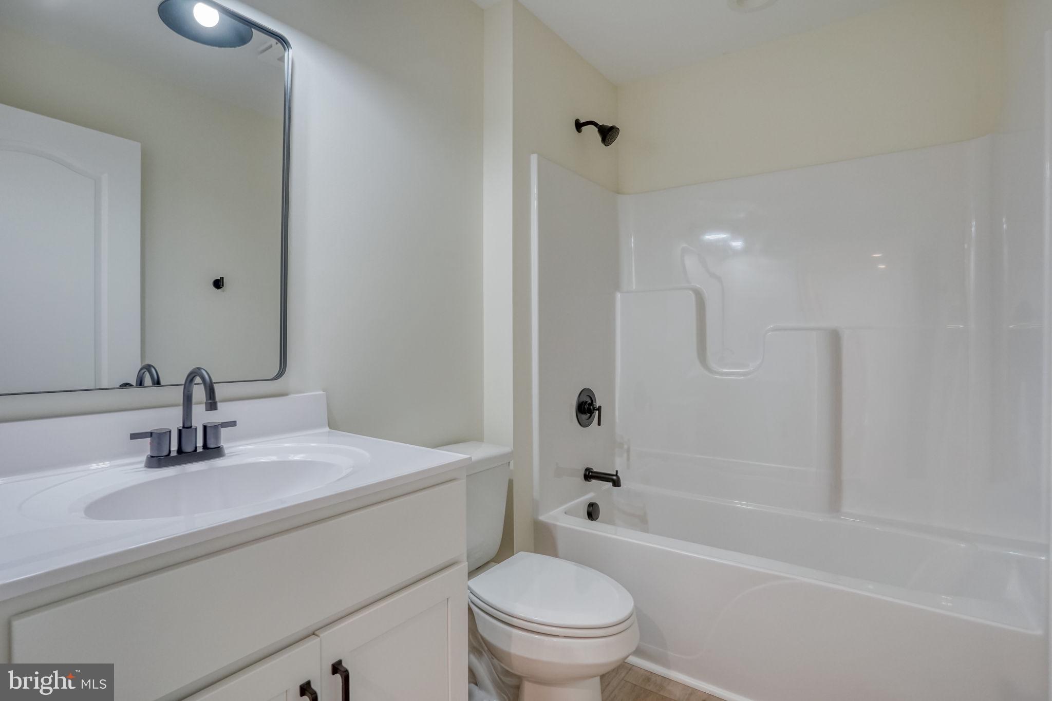 207 Charles Way Georgetown, DE 19947 - Photo 11 of 31 a bathroom with a sink toilet vanity and shower