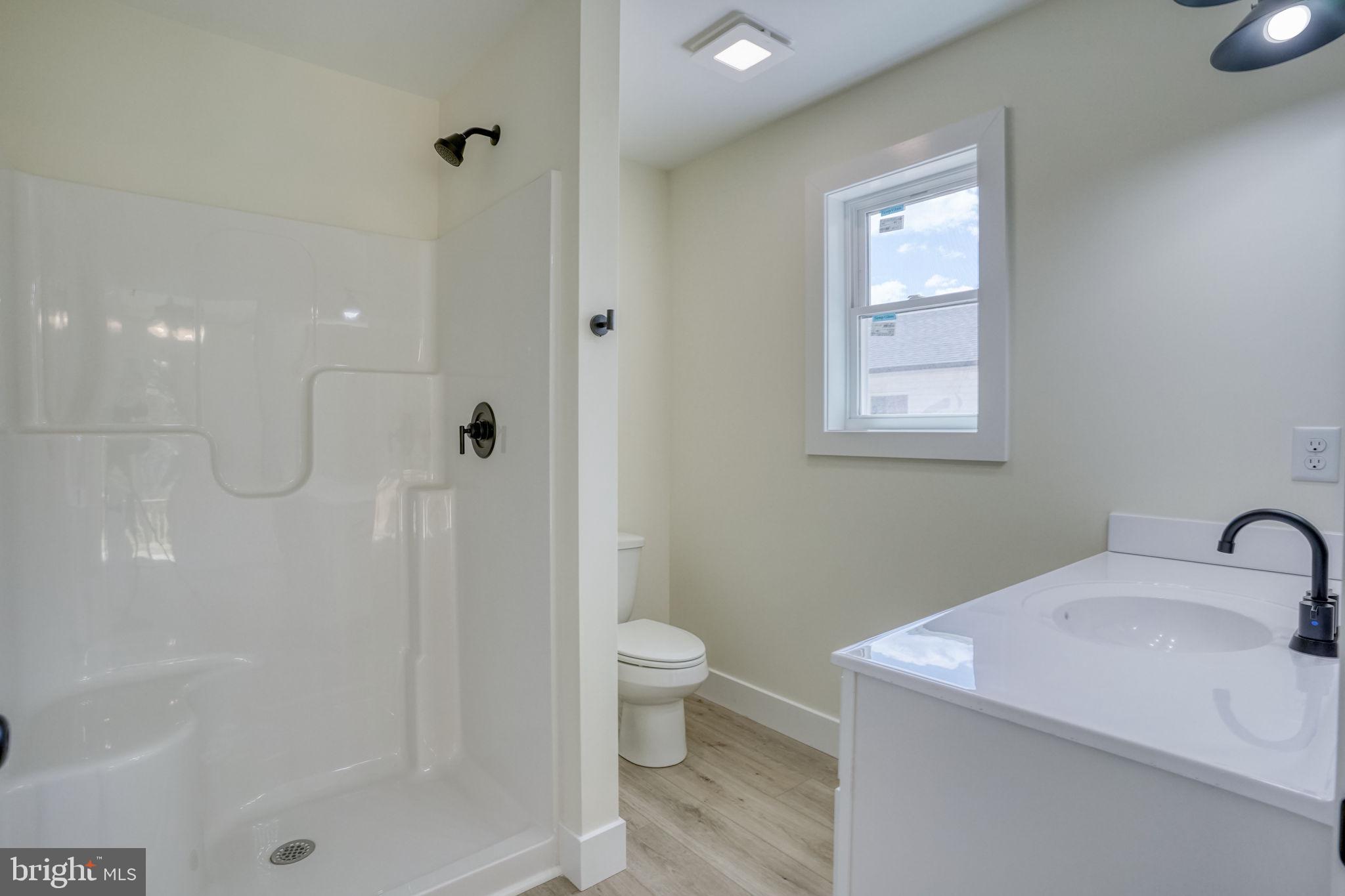 207 Charles Way Georgetown, DE 19947 - Photo 12 of 31 a bathroom with a sink a toilet and shower