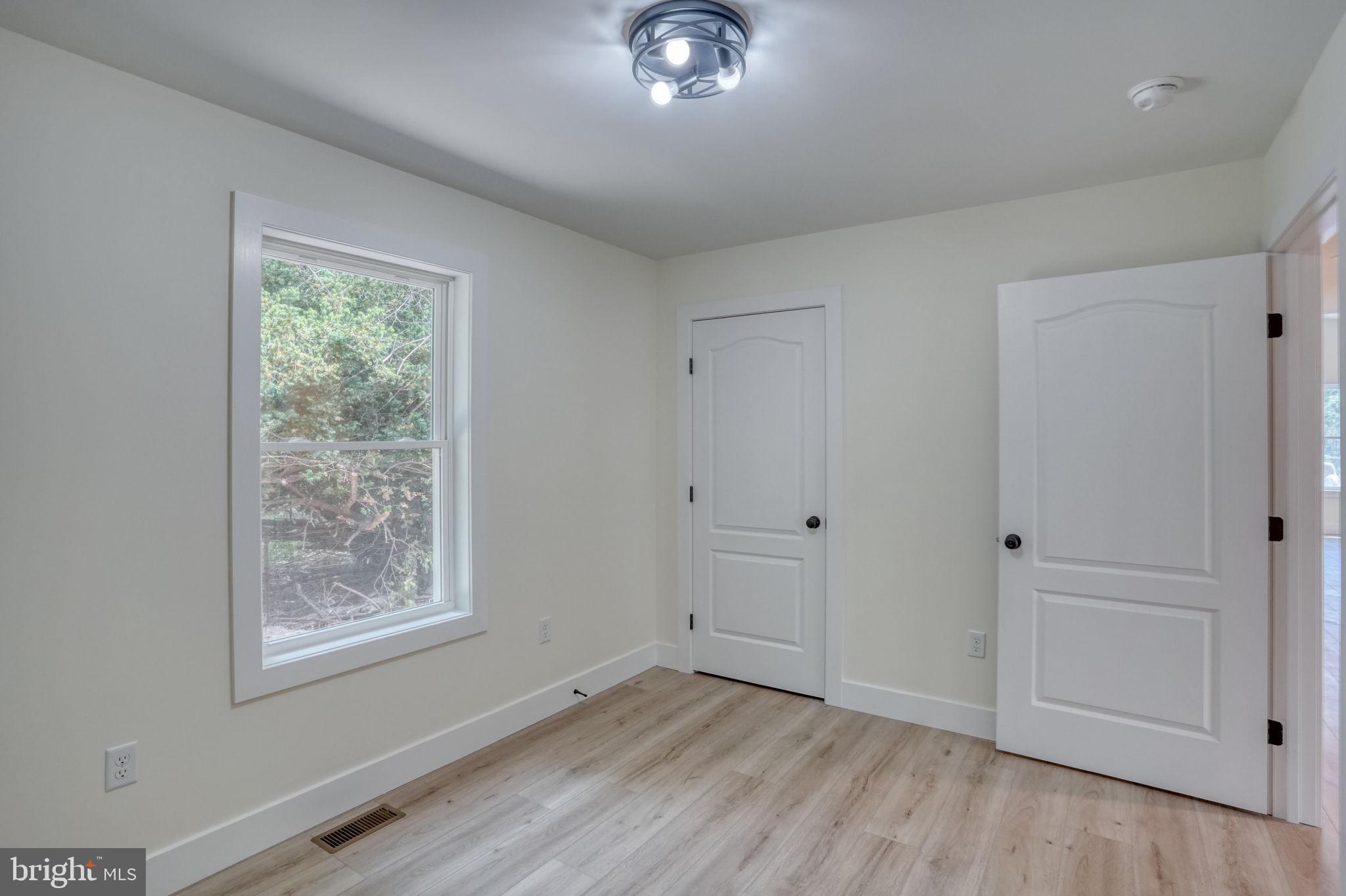 207 Charles Way Georgetown, DE 19947 - Photo 17 of 31 a view of an empty room with window and wooden floor
