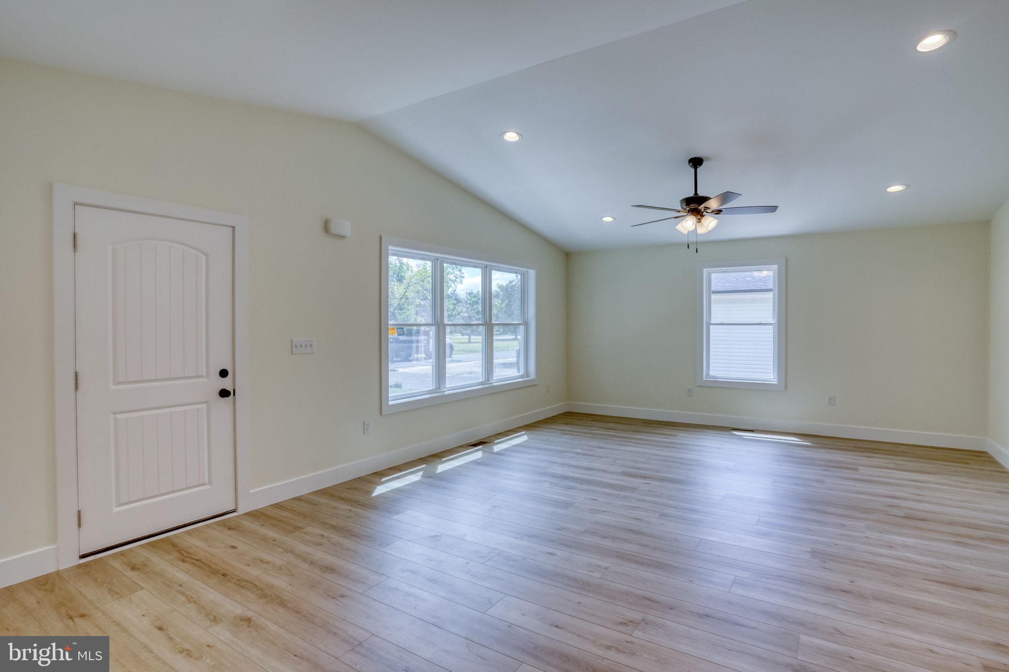 207 Charles Way Georgetown, DE 19947 - Photo 22 of 31 a view of an empty room with wooden floor and a window