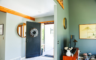 578 High Bench Road Alpine, UT 84004 - Photo 18 of 39 Entryway featuring a dark paneled door, wood-finish trim, and a circular wall mirror