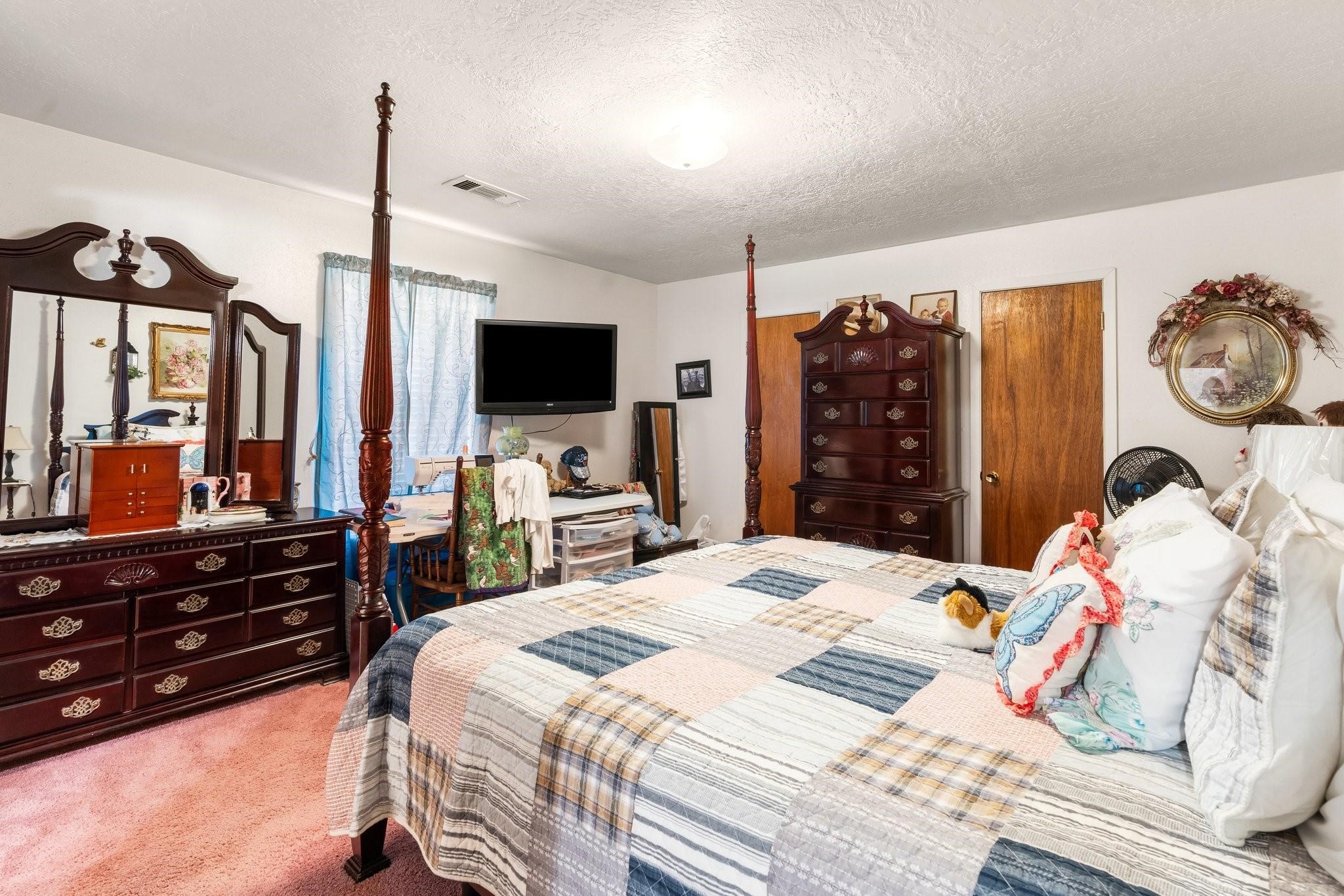 15091 Farm To Market 1485 Conroe, TX 77306 - Photo 10 of 28 a bedroom with a bed and flat screen tv