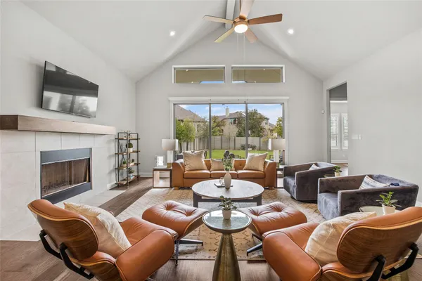 a living room with furniture fireplace and flat screen tv