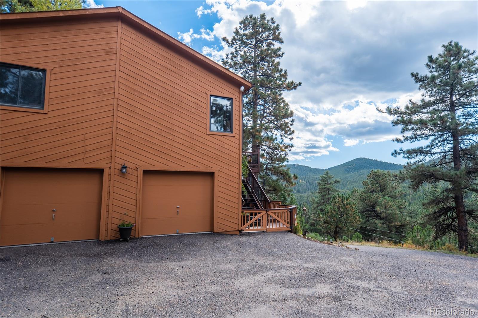 32947 Little Cub Road Evergreen, CO 80439 - Photo 33 of 37 a view of a house with a garage