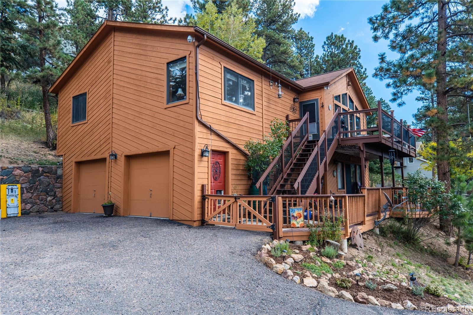 32947 Little Cub Road Evergreen, CO 80439 - Photo 34 of 37 a view of a house with a yard