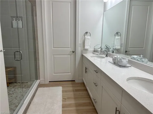 a bathroom with a double vanity sink and a mirror