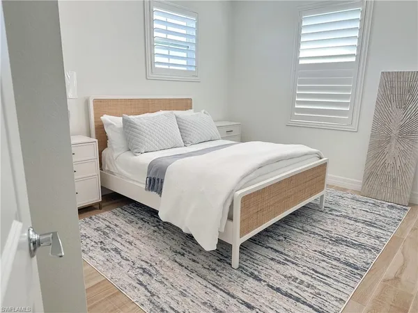 a bed sitting in a bedroom next to a window