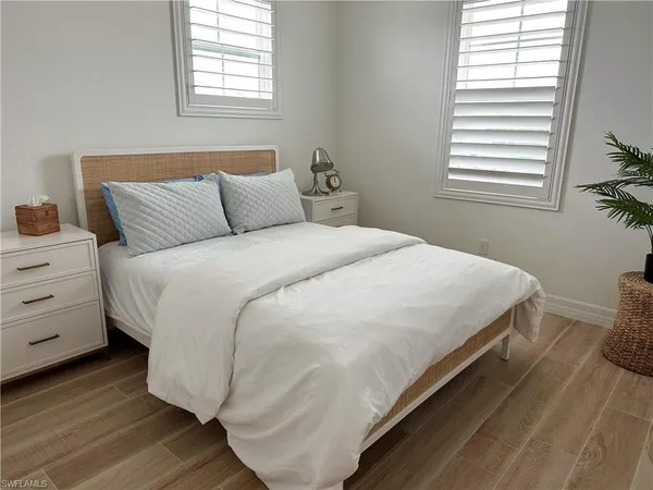 a bedroom with bed and window