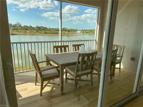 a view of a balcony with chairs and wooden floor