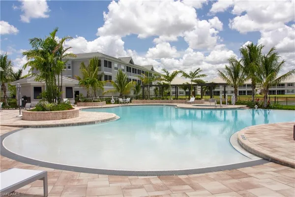 a view of a swimming pool with outdoor seating