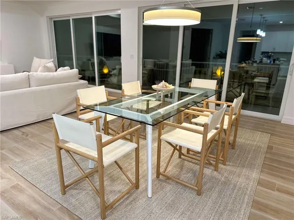 a view of a dining room with furniture and chandelier