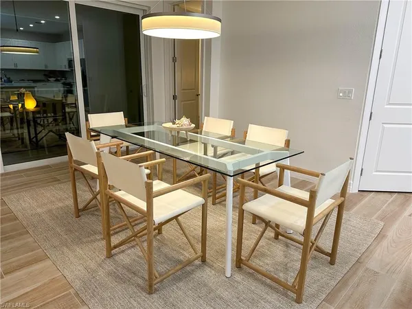 a view of a dining room with furniture and a chandelier