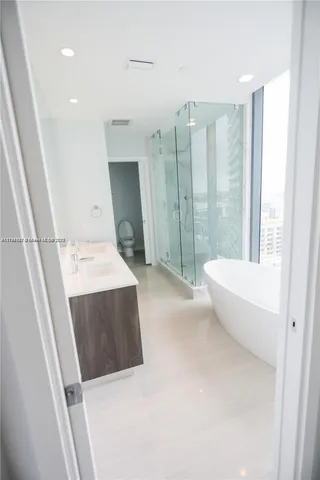 a white bath tub sitting in front of a window