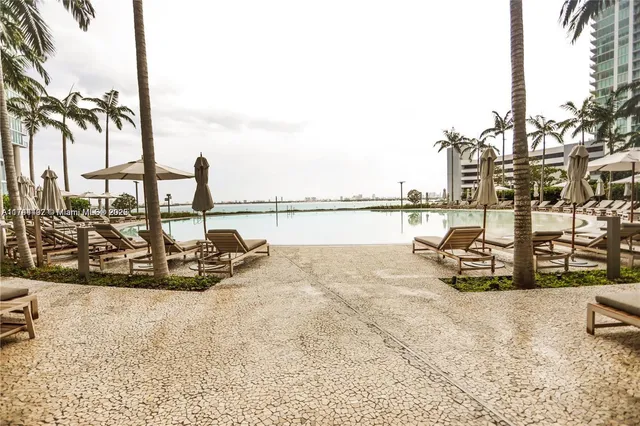 a view of a swimming pool with outdoor seating
