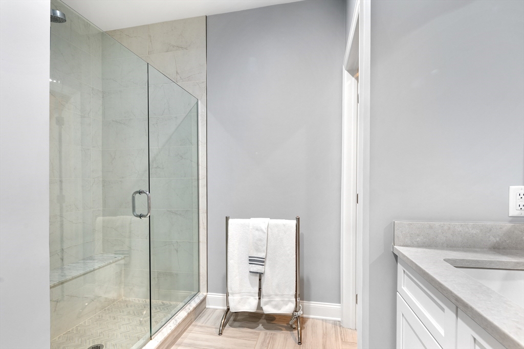 10 Benjamin Lane, Unit 10 Scituate, MA 02066 - Photo 22 of 42 a bathroom with a granite countertop sink and shower