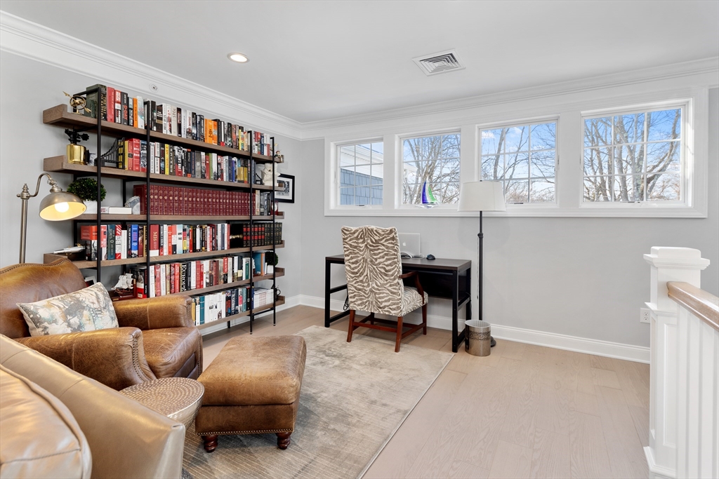 10 Benjamin Lane, Unit 10 Scituate, MA 02066 - Photo 25 of 42 a living room with furniture and a book shelf