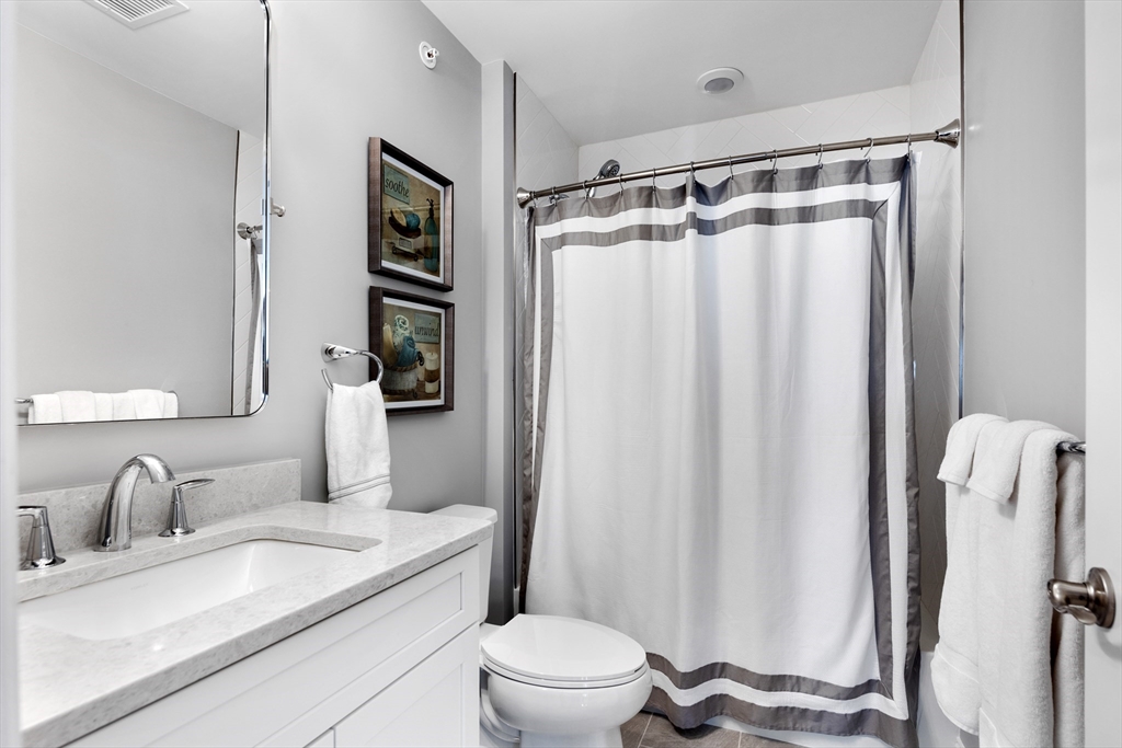 10 Benjamin Lane, Unit 10 Scituate, MA 02066 - Photo 27 of 42 a bathroom with a granite countertop sink toilet and shower