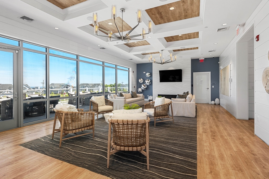 10 Benjamin Lane, Unit 10 Scituate, MA 02066 - Photo 34 of 42 a living room with lots of furniture and a flat screen tv