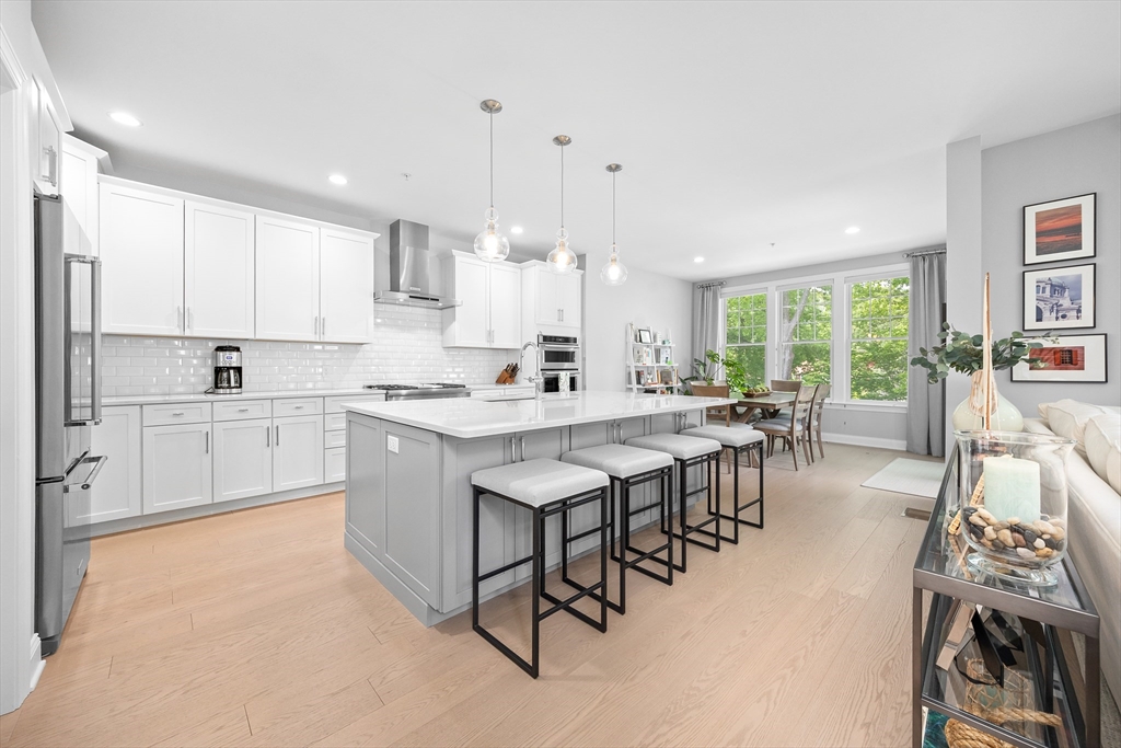10 Benjamin Lane, Unit 10 Scituate, MA 02066 - Photo 9 of 42 a large kitchen with a large window and white cabinets