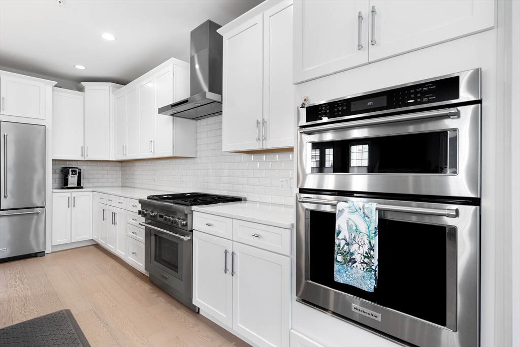 10 Benjamin Lane, Unit 10 Scituate, MA 02066 - Photo 10 of 42 a kitchen with stainless steel appliances white cabinets and a stove