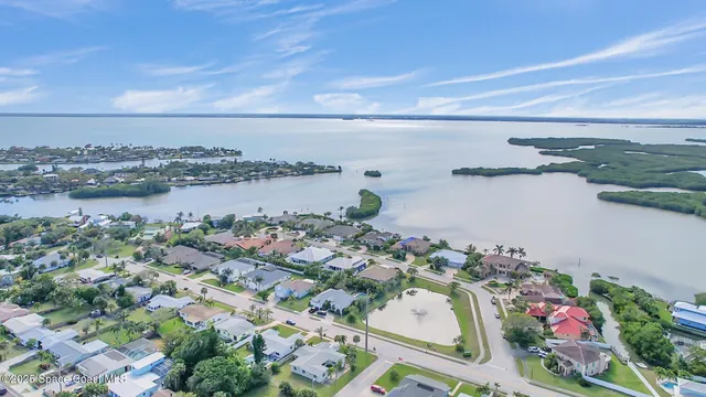 a living room with furniture a chandelier and a fireplace