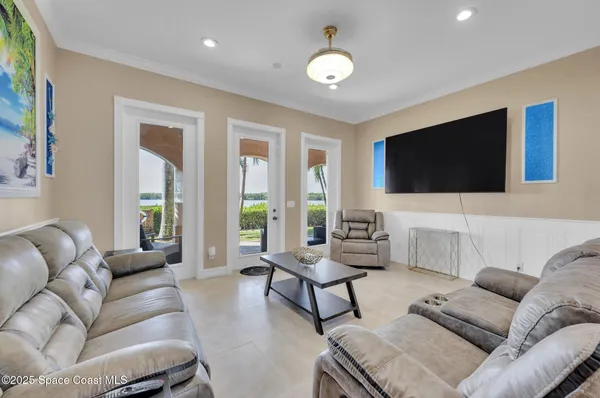 a kitchen with a dining table chairs wooden floor appliances and cabinets
