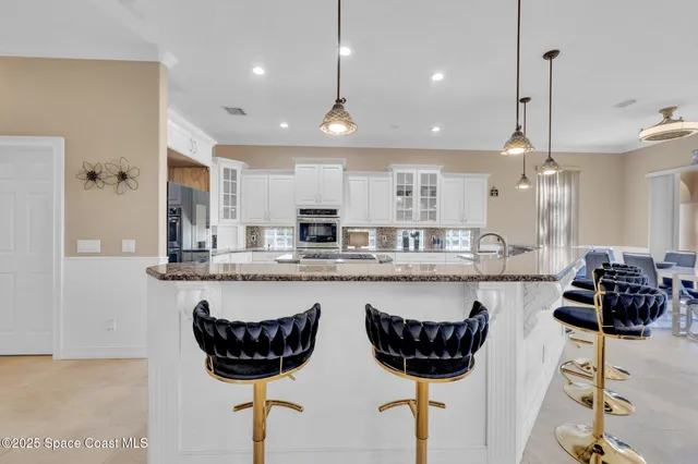 a kitchen with stainless steel appliances granite countertop a sink and cabinets