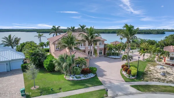 an aerial view of a house with a lake view
