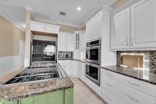 a spacious bedroom with a large bed and a flat screen tv