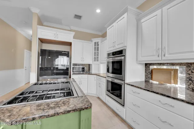 a spacious bedroom with a large bed and a flat screen tv