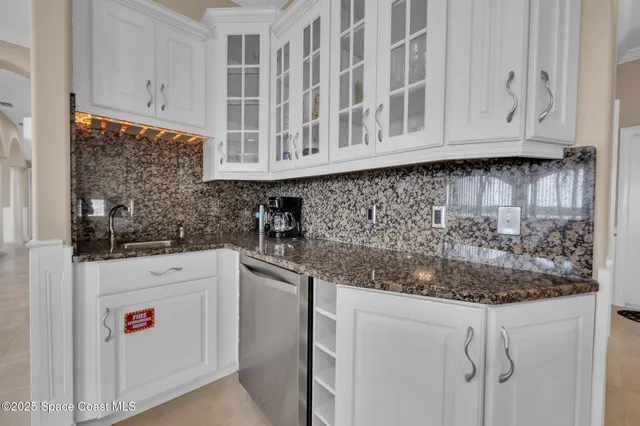 a spacious bathroom with a granite countertop sink and a mirror