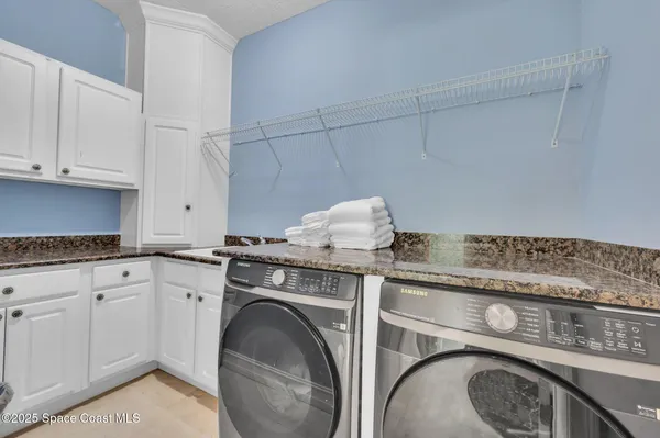 a spacious bathroom with a tub sink and mirror