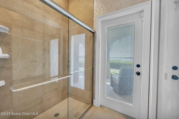 a bedroom with a large bed and a flat tv screen on dresser