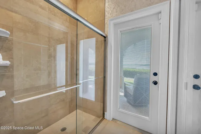 a bedroom with a large bed and a flat tv screen on dresser