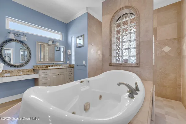 a bathroom with a granite countertop sink mirror vanity and toilet