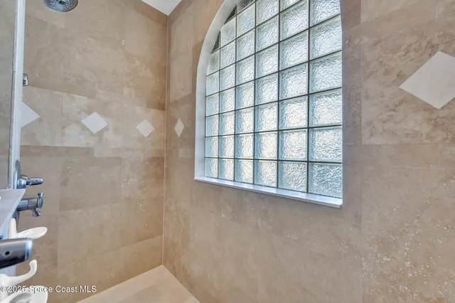 a spacious bedroom with a large bed and a large window