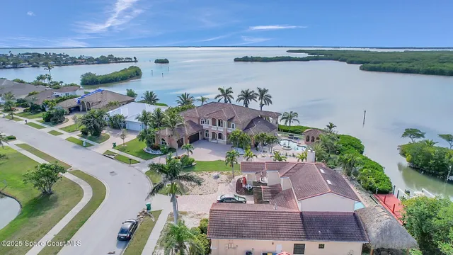 an aerial view of a house with outdoor space and lake view