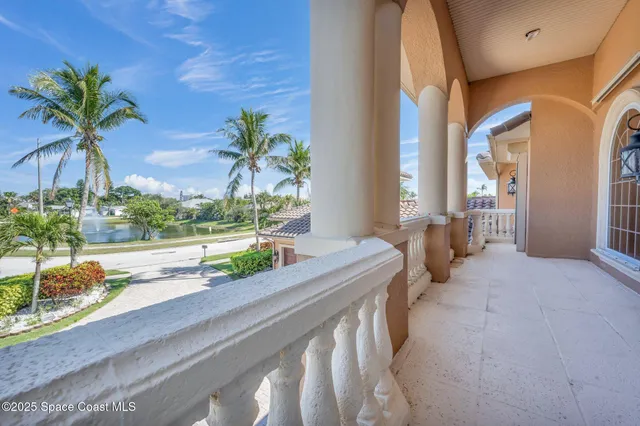 a bedroom with a large bed a flat tv screen and balcony