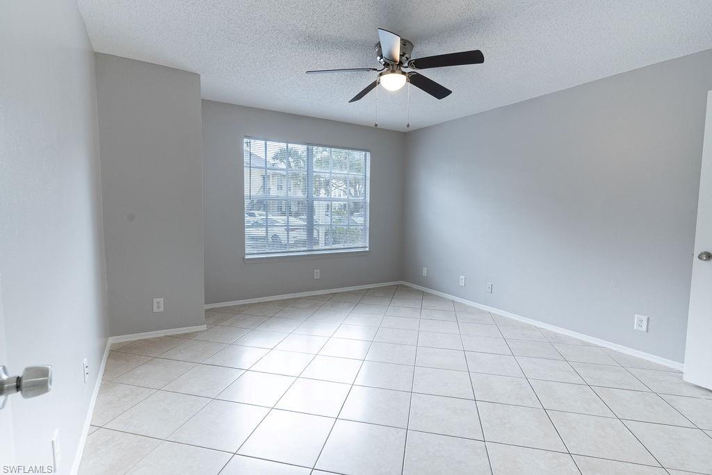 2045 Rookery Bay Drive, Unit 1901 Naples, FL 34114 - Photo 17 of 18 Unfurnished room featuring a textured ceiling, a ceiling fan, and light tile patterned floors