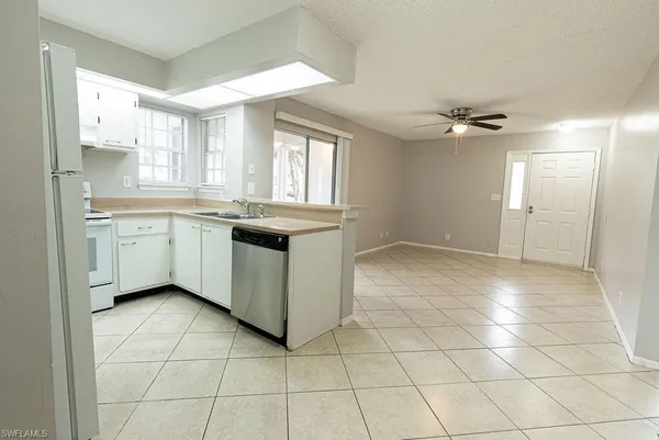 a view of an empty room and a ceiling fan