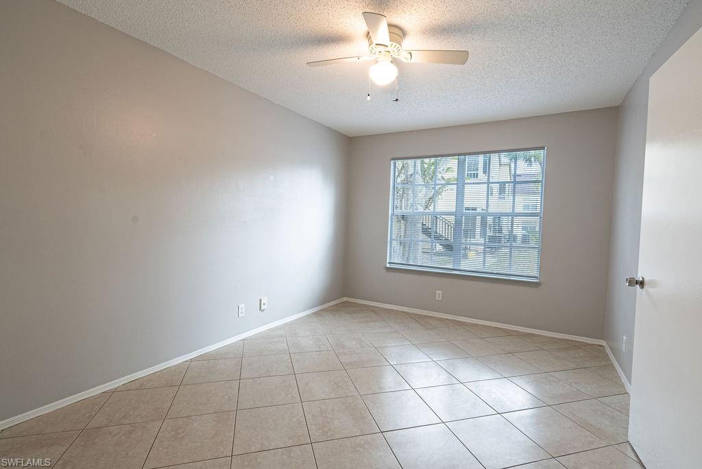 2045 Rookery Bay Drive, Unit 1901 Naples, FL 34114 - Photo 10 of 18 Unfurnished room featuring light tile patterned floors, a textured ceiling, and ceiling fan
