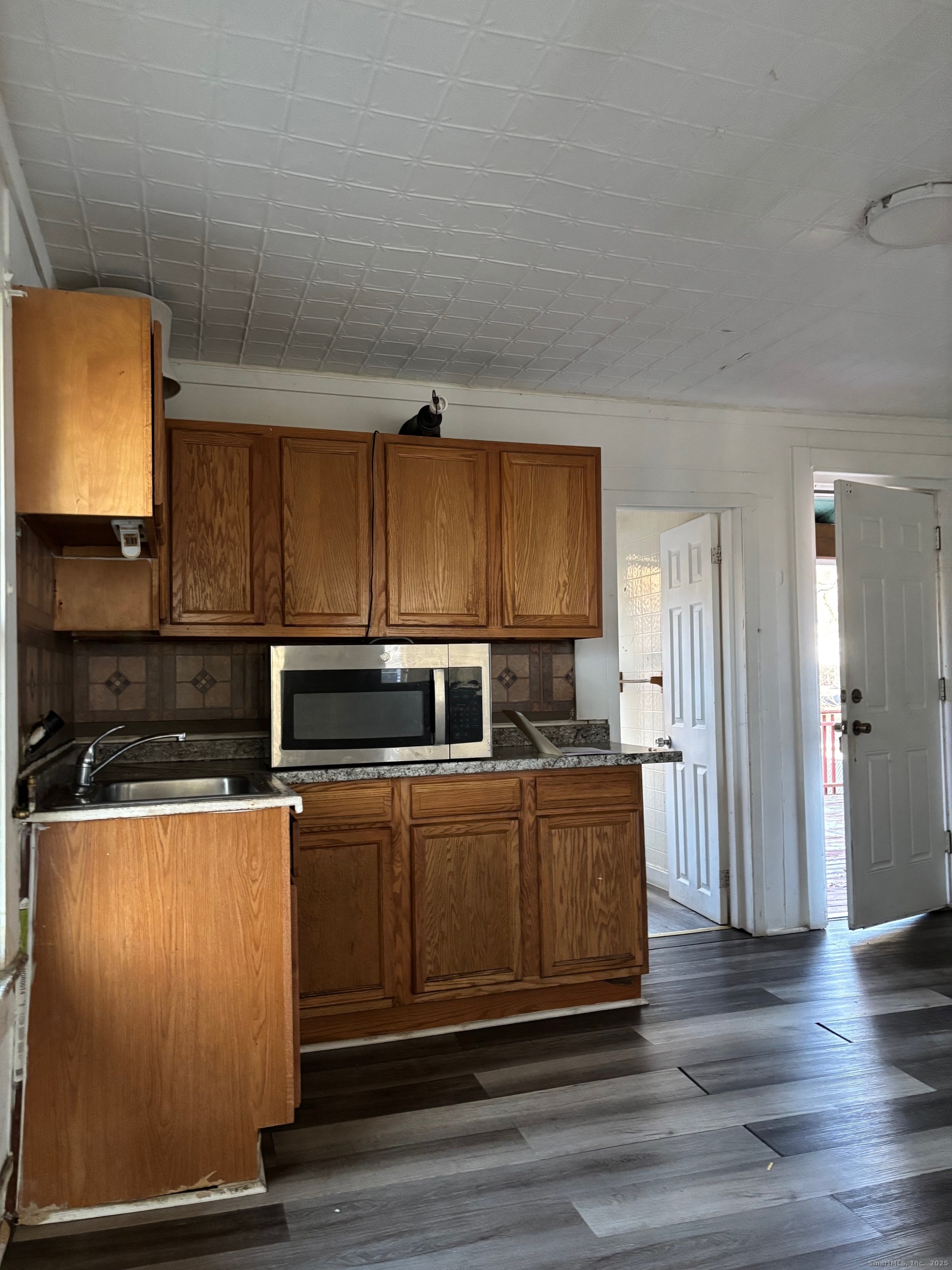 113 Southview Street Waterbury, CT 06706 - Photo 3 of 6 a kitchen with stainless steel appliances a stove a microwave a sink and cabinets