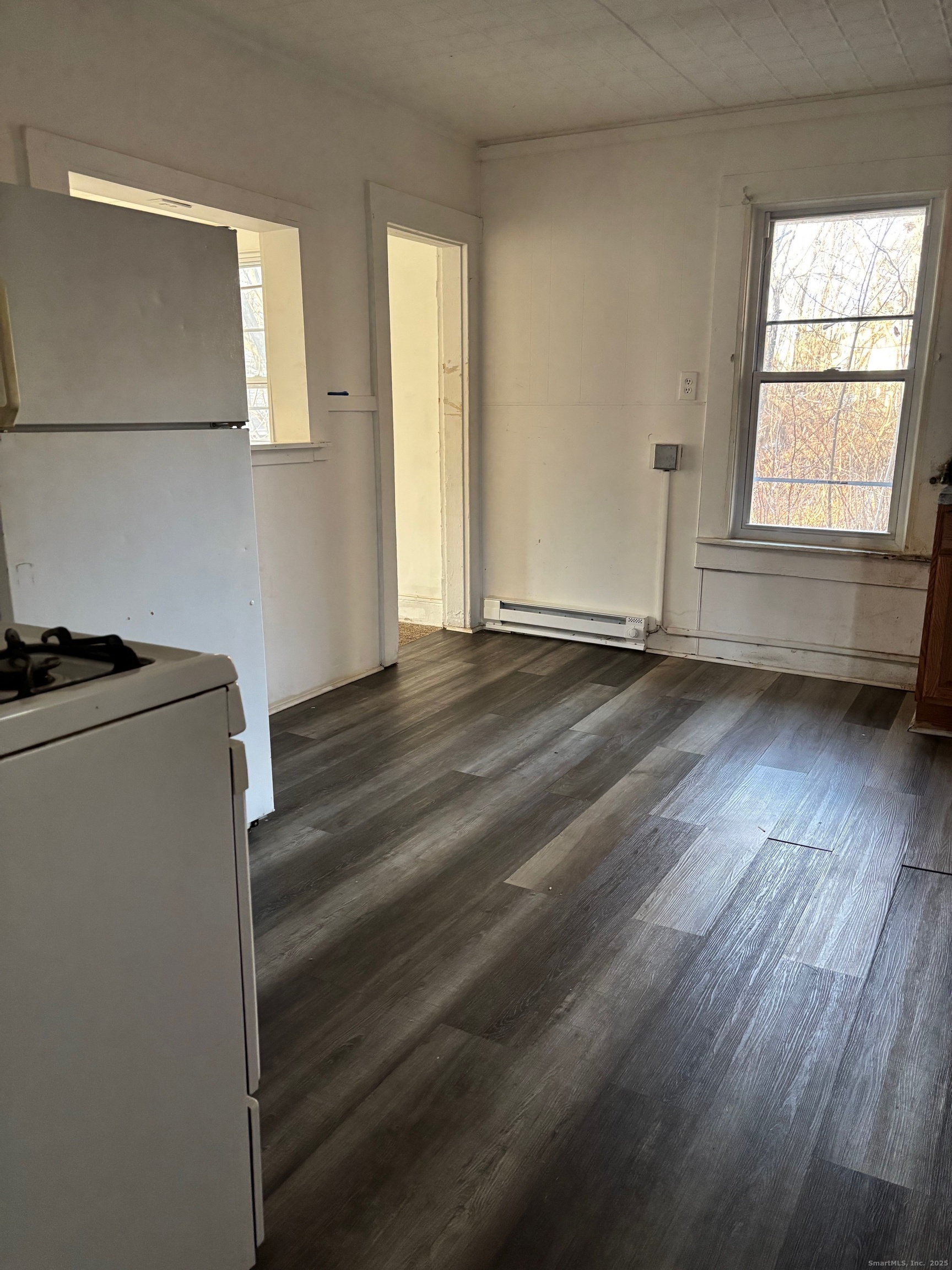 113 Southview Street Waterbury, CT 06706 - Photo 4 of 6 a view of an empty room with wooden floor and a window