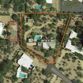 an aerial view of residential house with parking