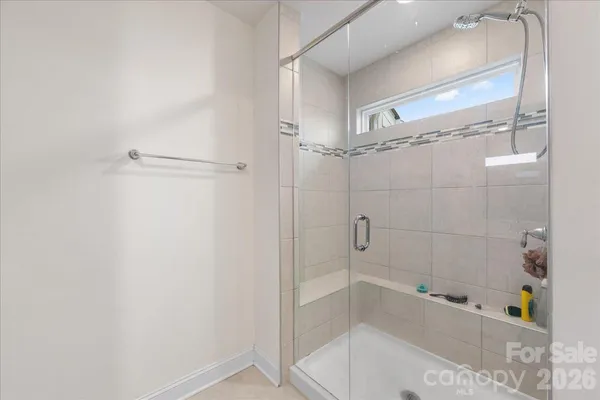 a bathroom with a bathtub and shower